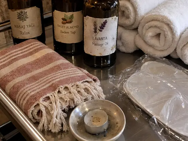 Masaj yağı şişeleri, rulo havlular ve pembe peştemal — Laleli, Masaj Salonun